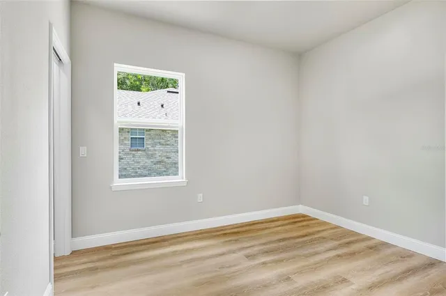 a view of kitchen with microwave and white cabinets