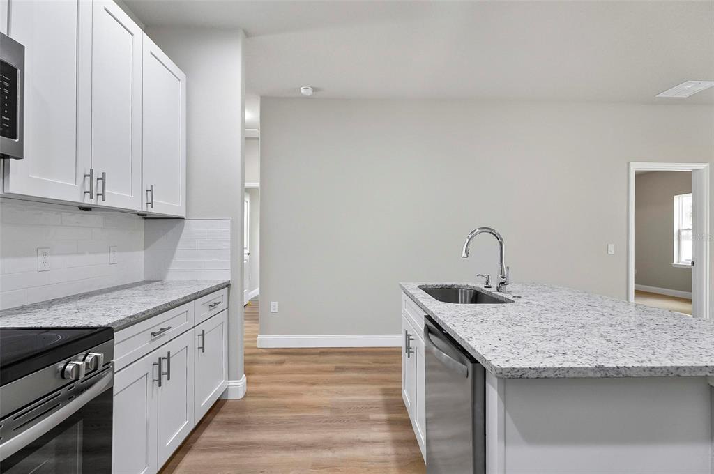 43 Eton Lane, Unit A Palm Coast, FL 32164 - Photo 64 of 78 a kitchen with granite countertop white cabinets and a sink