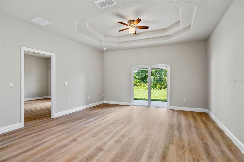 43 Eton Lane, Unit A Palm Coast, FL 32164 - Photo 67 of 78 a view of an empty room with a window and wooden floor