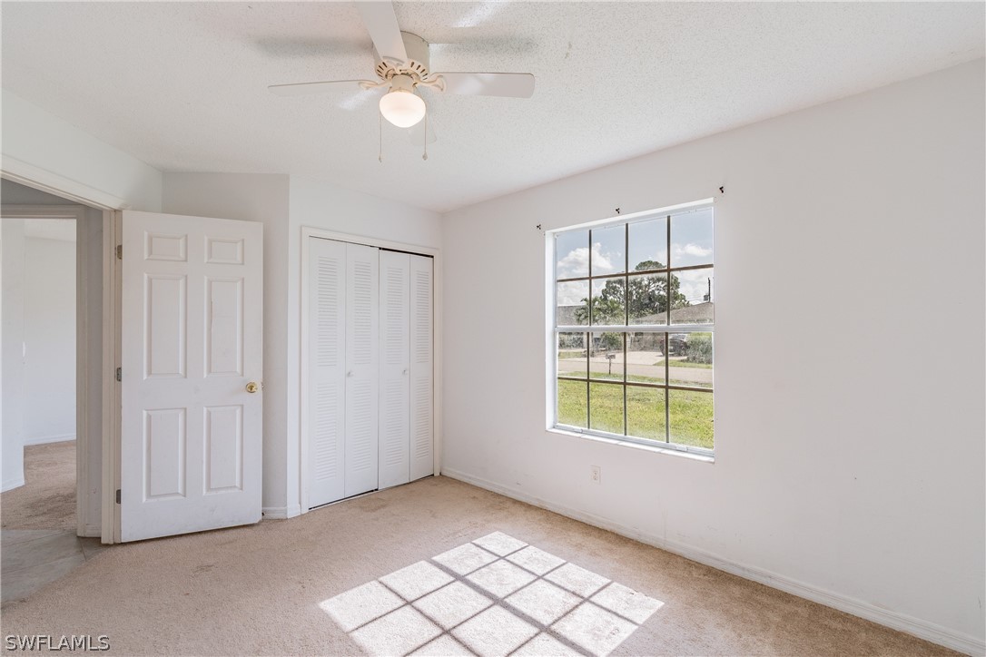 17552 Lebanon Road Fort Myers, FL 33967 - Photo 19 of 35 an empty room with windows and fan