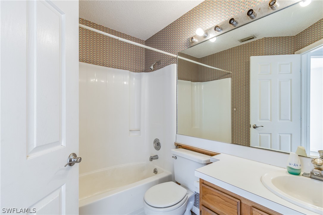 17552 Lebanon Road Fort Myers, FL 33967 - Photo 21 of 35 a bathroom with a sink a toilet and a bathtub