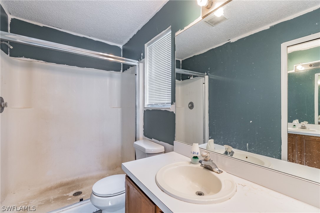 17552 Lebanon Road Fort Myers, FL 33967 - Photo 25 of 35 a bathroom with a sink toilet and shower