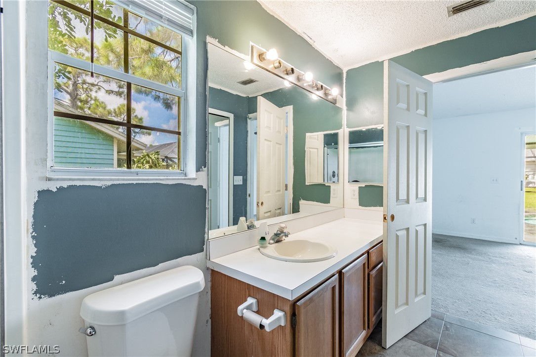17552 Lebanon Road Fort Myers, FL 33967 - Photo 26 of 35 a bathroom with a sink a toilet and a mirror