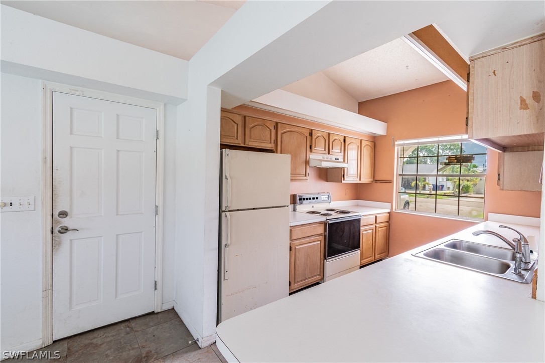 17552 Lebanon Road Fort Myers, FL 33967 - Photo 31 of 35 a kitchen with stainless steel appliances granite countertop a refrigerator a stove a sink and a microwave