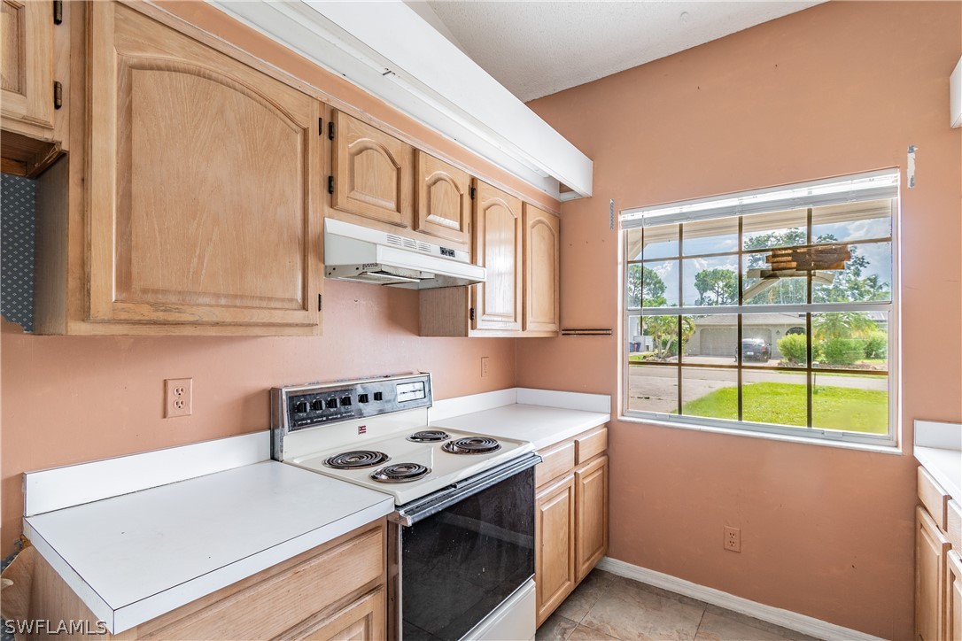 17552 Lebanon Road Fort Myers, FL 33967 - Photo 34 of 35 a kitchen with a stove and a sink