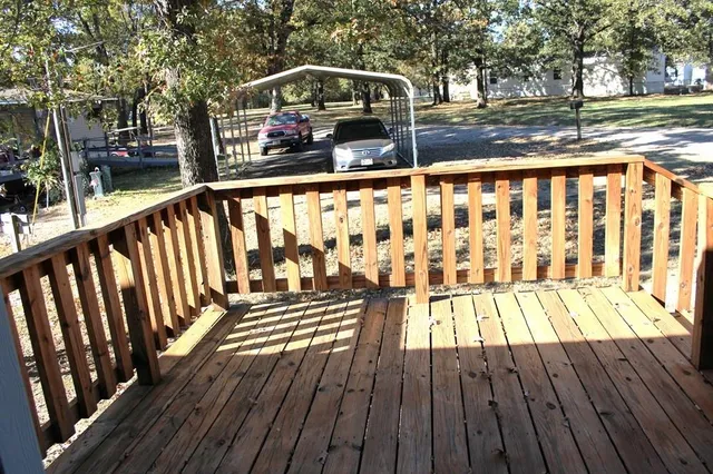a view of balcony with wooden floor and fence