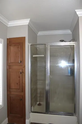a bathroom with a glass shower door