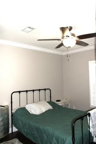 a bedroom with a bed and window