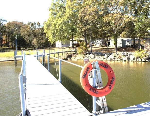 a swimming pool with outdoor seating and outdoor kitchen