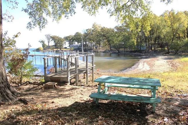 a view of a lake with lawn chairs