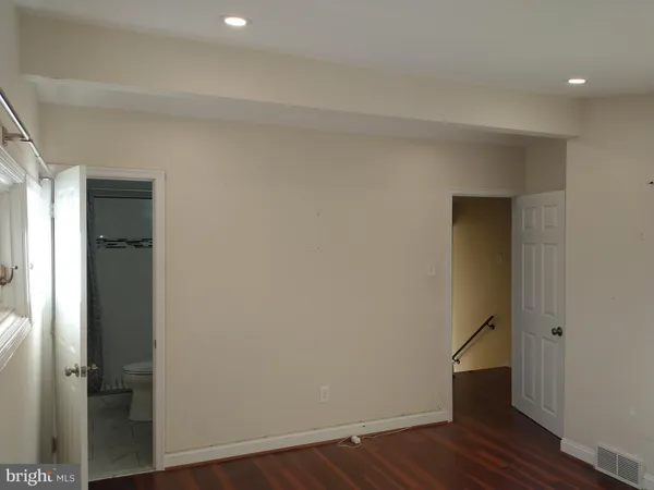 a bathroom with a granite countertop shower and a toilet