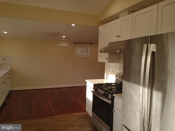 a kitchen with wooden cabinets and stainless steel appliances
