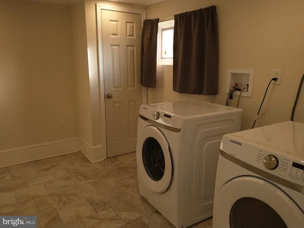 a white toilet sitting next to a white sink and vanity