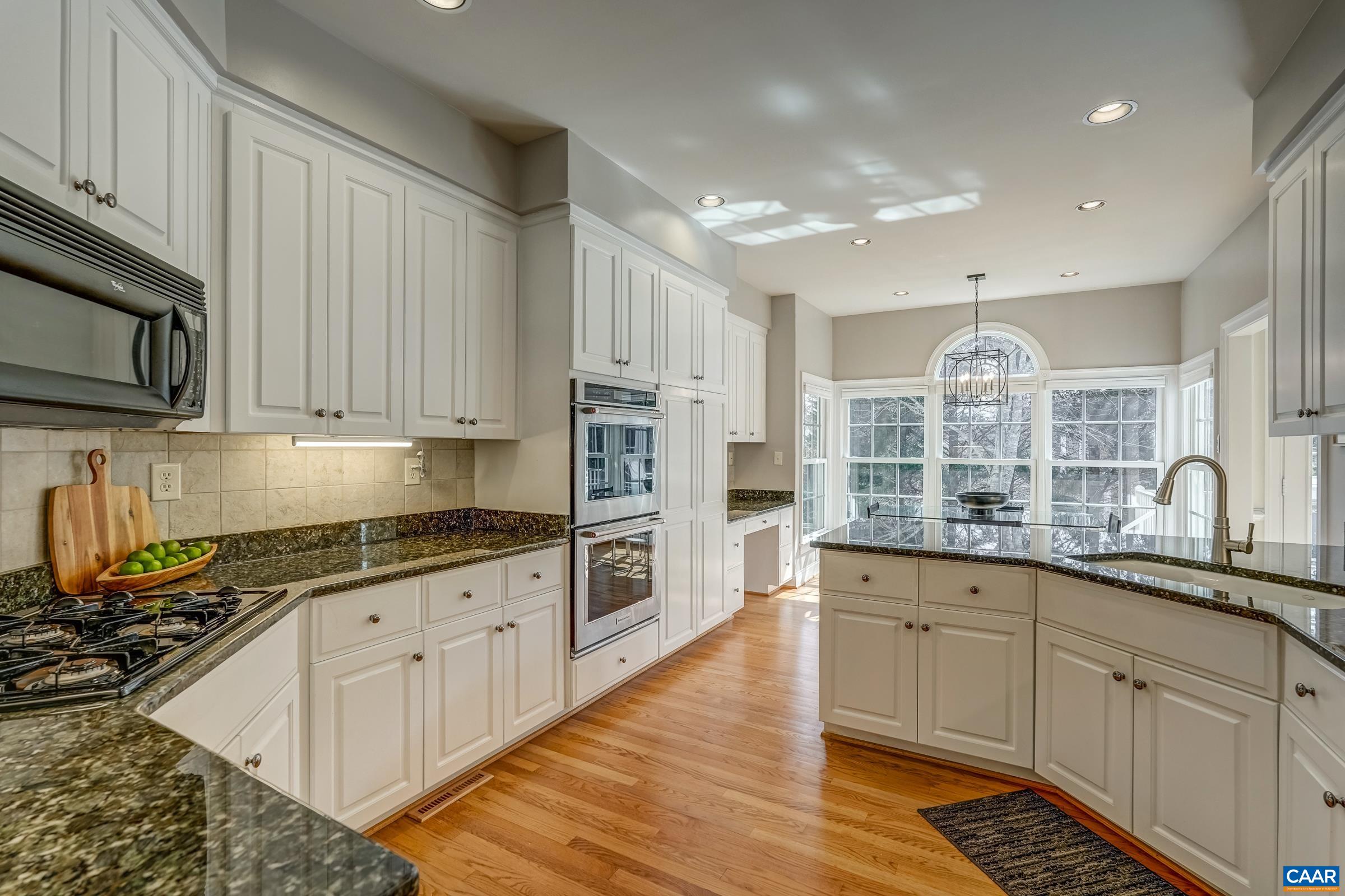 3434 Darby Road Keswick, VA 22947 - Photo 13 of 45 a kitchen with stainless steel appliances granite countertop a stove a sink dishwasher and a microwave oven with wooden cabinets