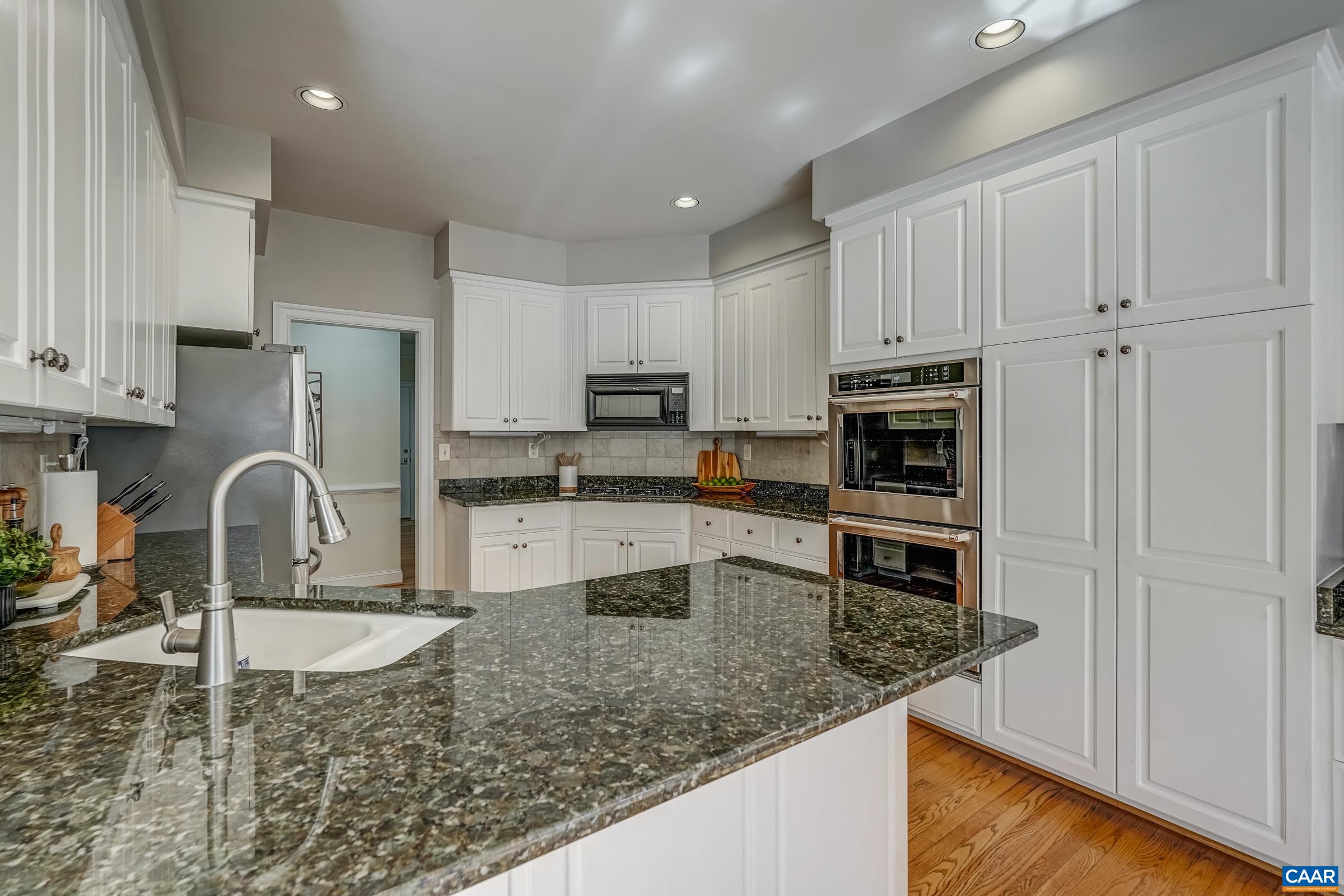 3434 Darby Road Keswick, VA 22947 - Photo 14 of 45 a kitchen with stainless steel appliances granite countertop a refrigerator a stove a sink and white cabinets with wooden floor