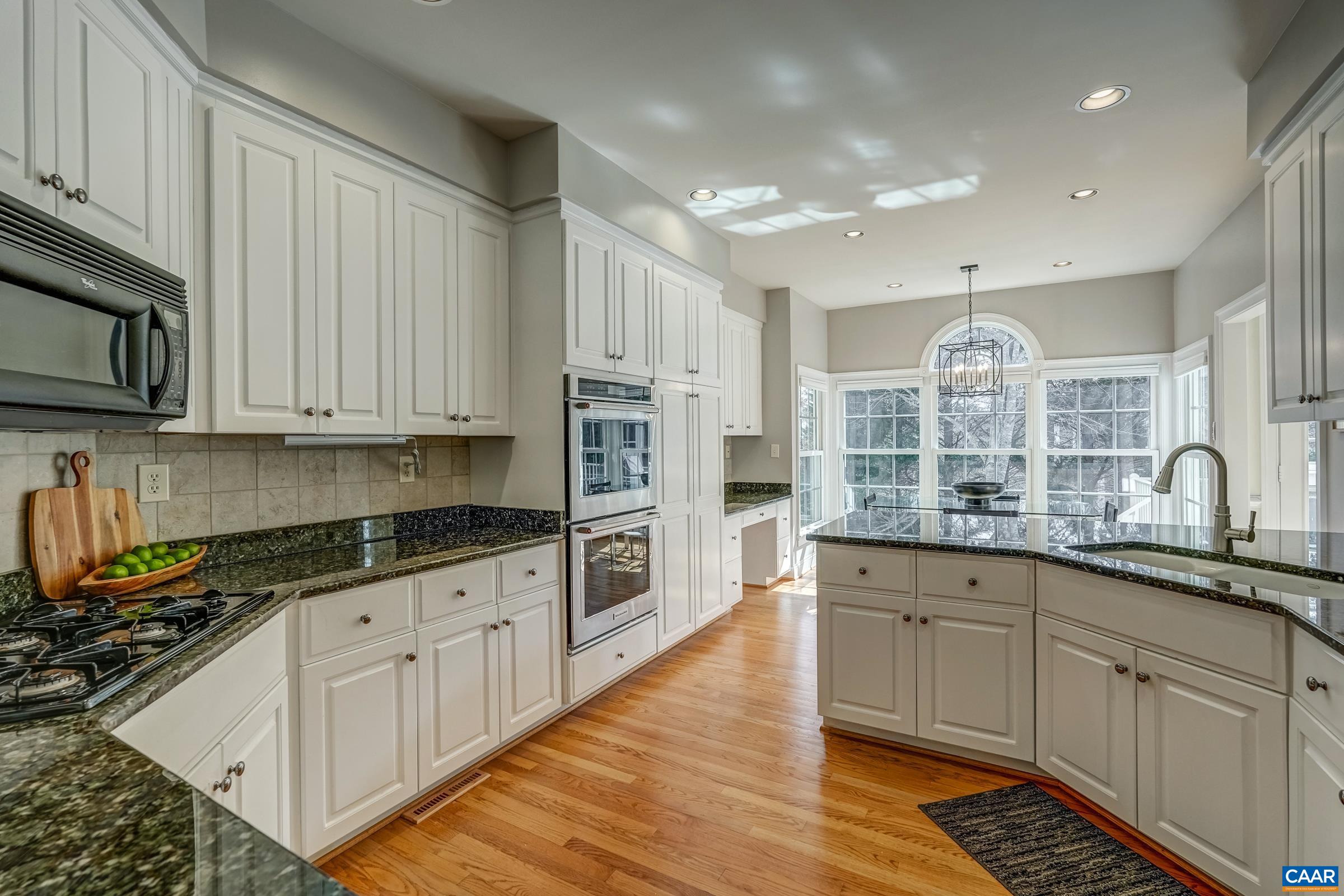 3434 Darby Road Keswick, VA 22947 - Photo 16 of 45 a kitchen with stainless steel appliances granite countertop a stove a sink and white cabinets