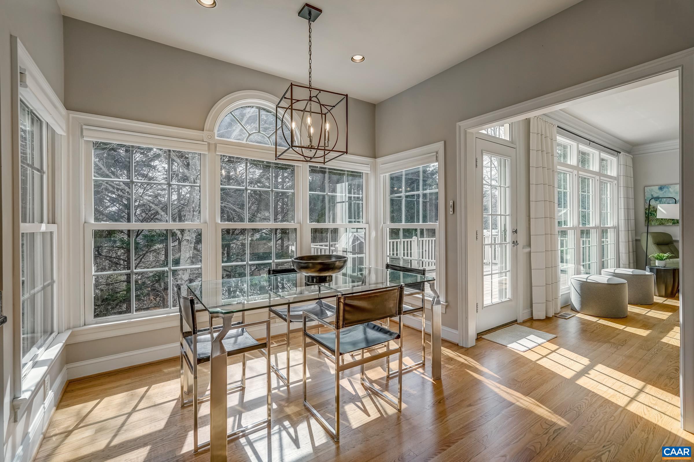 3434 Darby Road Keswick, VA 22947 - Photo 20 of 45 a view of a dining room with furniture large windows and wooden floor