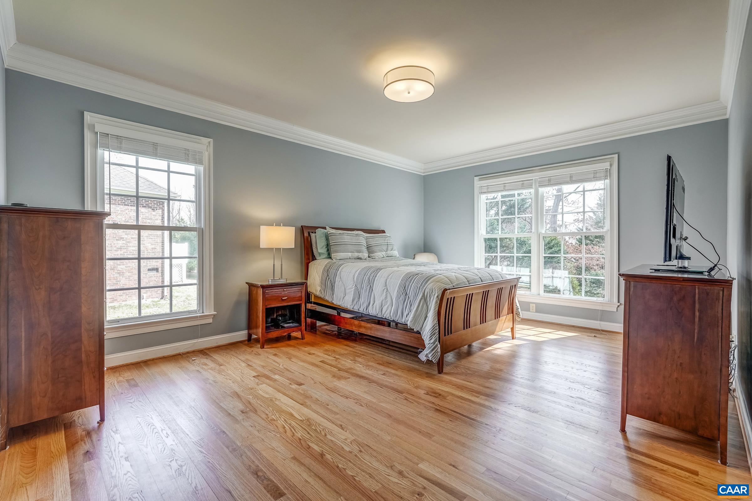 3434 Darby Road Keswick, VA 22947 - Photo 21 of 45 a bedroom with a bed and wooden floor
