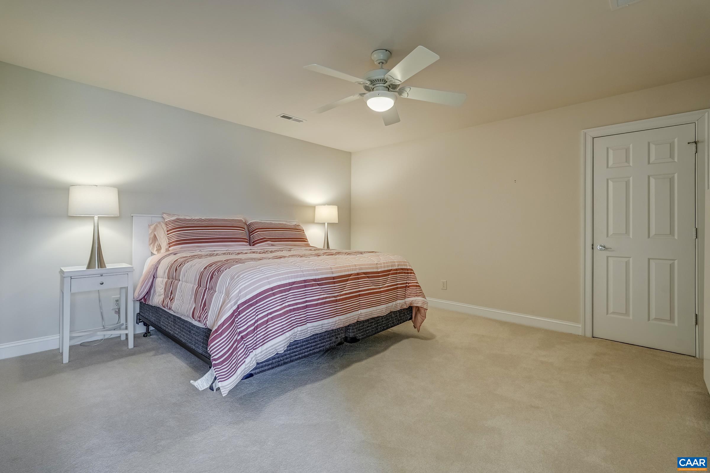 3434 Darby Road Keswick, VA 22947 - Photo 31 of 45 a bedroom with a bed and a chandelier