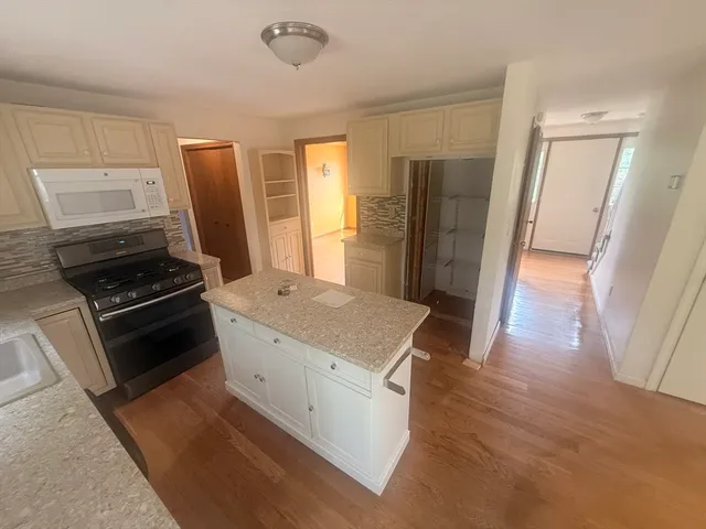 a kitchen with stainless steel appliances a refrigerator stove and sink