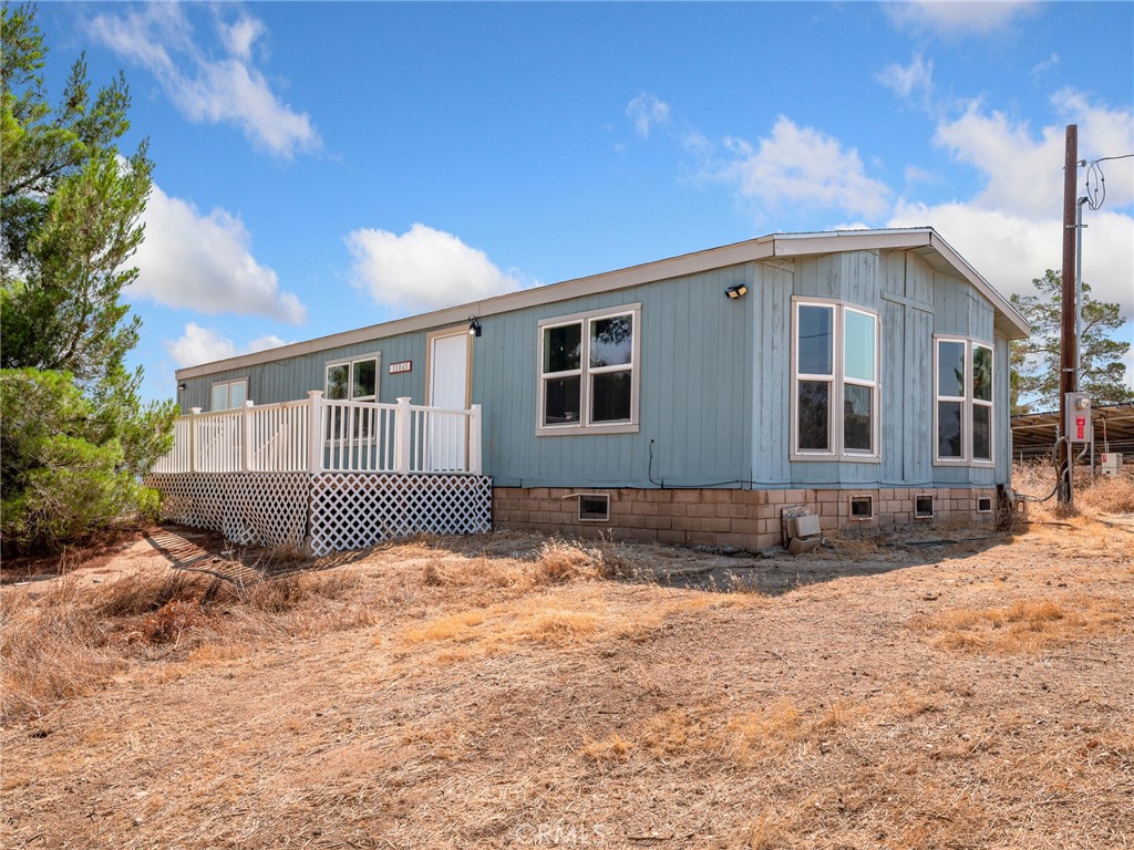 11065 Pacific Road Phelan, CA 92371 - Photo 1 of 1 a front view of a house with a yard