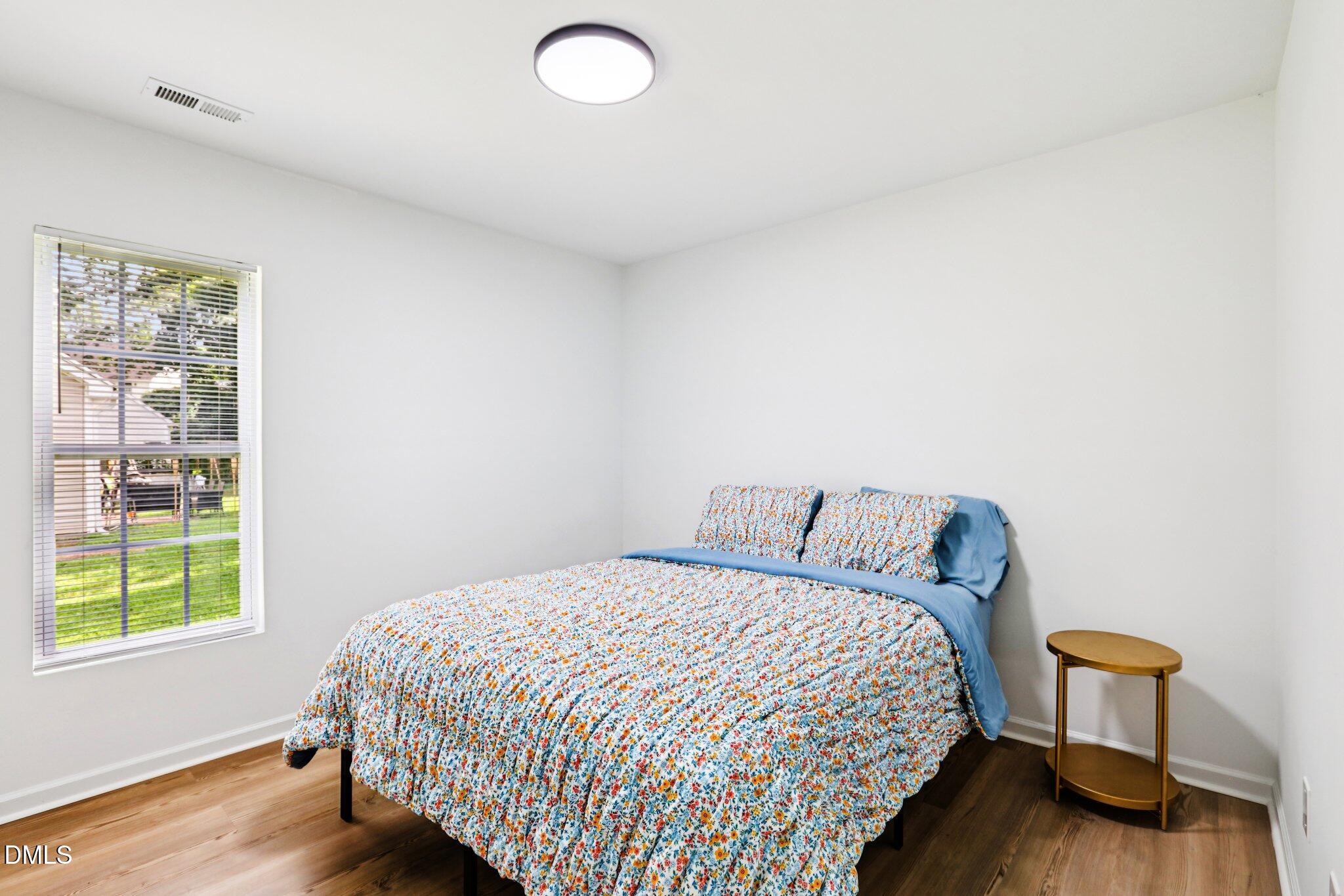1349 Crabtree Boulevard Raleigh, NC 27610 - Photo 11 of 21 a bedroom with a bed and a window