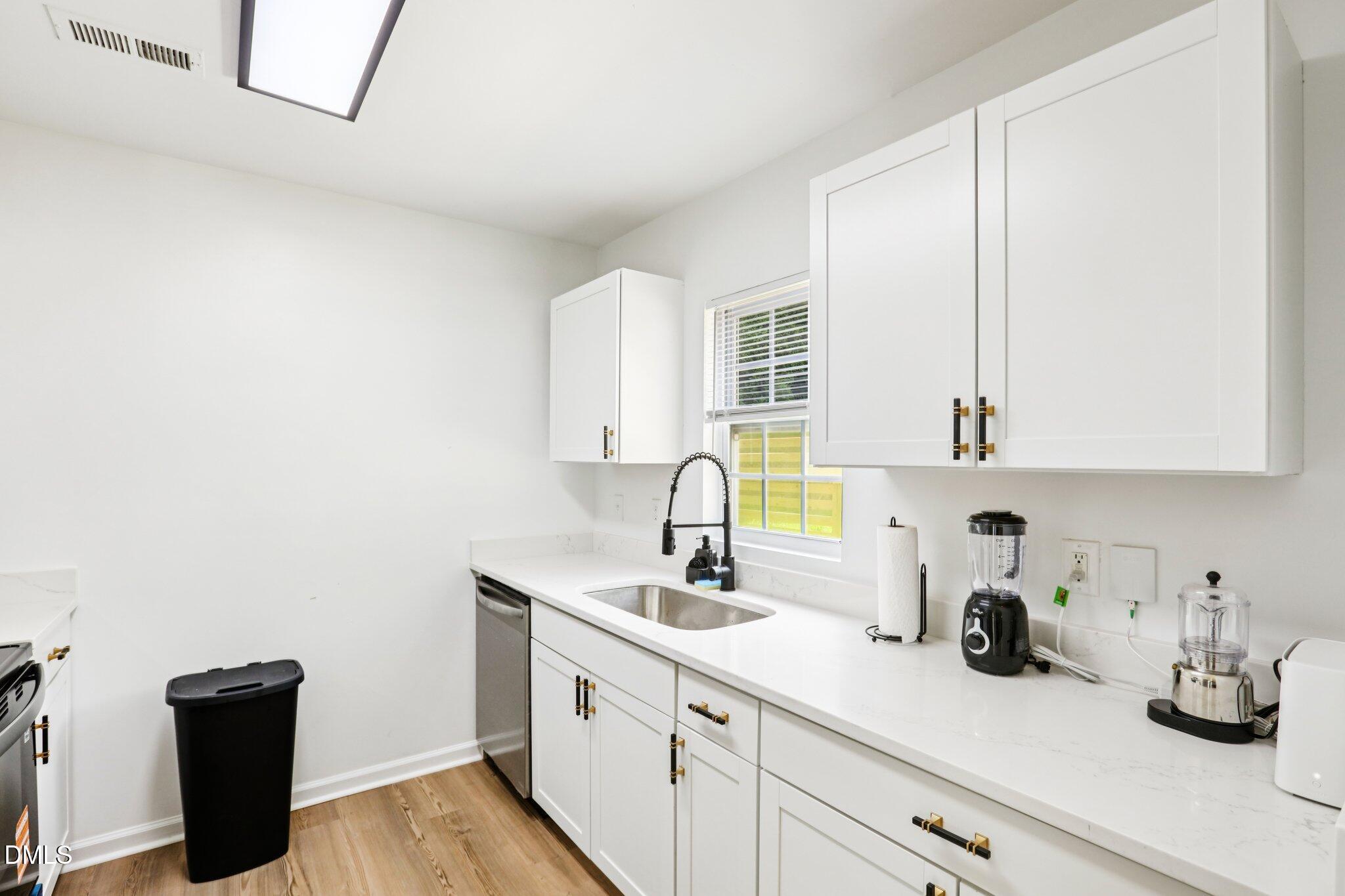 1349 Crabtree Boulevard Raleigh, NC 27610 - Photo 14 of 21 a kitchen with a sink cabinets and a window