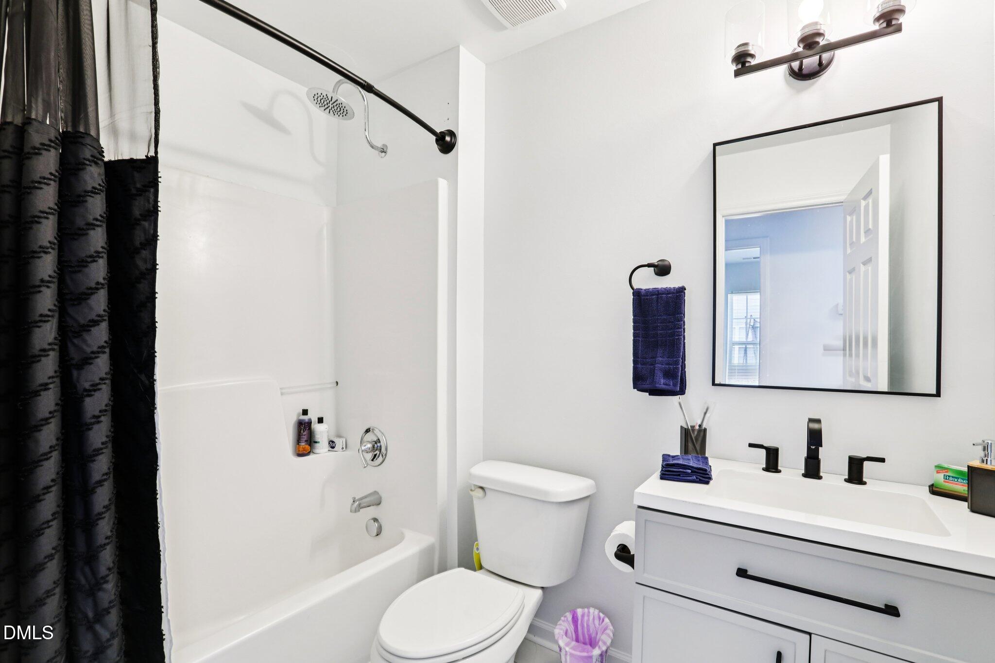 1349 Crabtree Boulevard Raleigh, NC 27610 - Photo 17 of 21 a bathroom with a sink vanity mirror and toilet