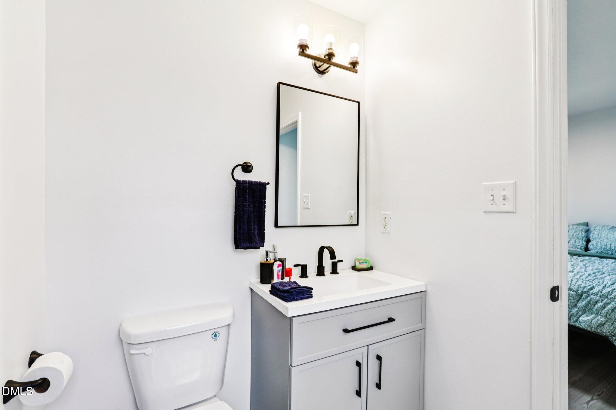 1349 Crabtree Boulevard Raleigh, NC 27610 - Photo 18 of 21 a bathroom with a sink and a mirror