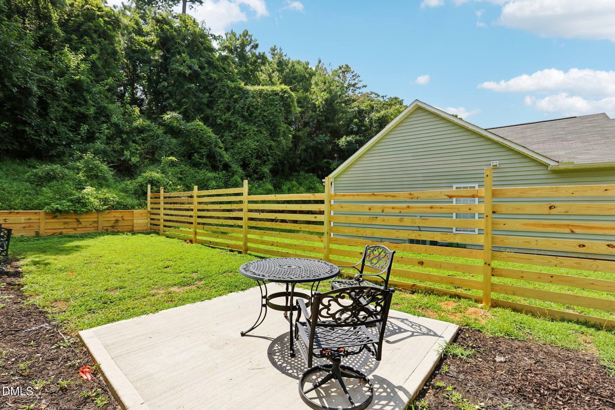 1349 Crabtree Boulevard Raleigh, NC 27610 - Photo 19 of 21 a view of a backyard with table and chairs and potted plants
