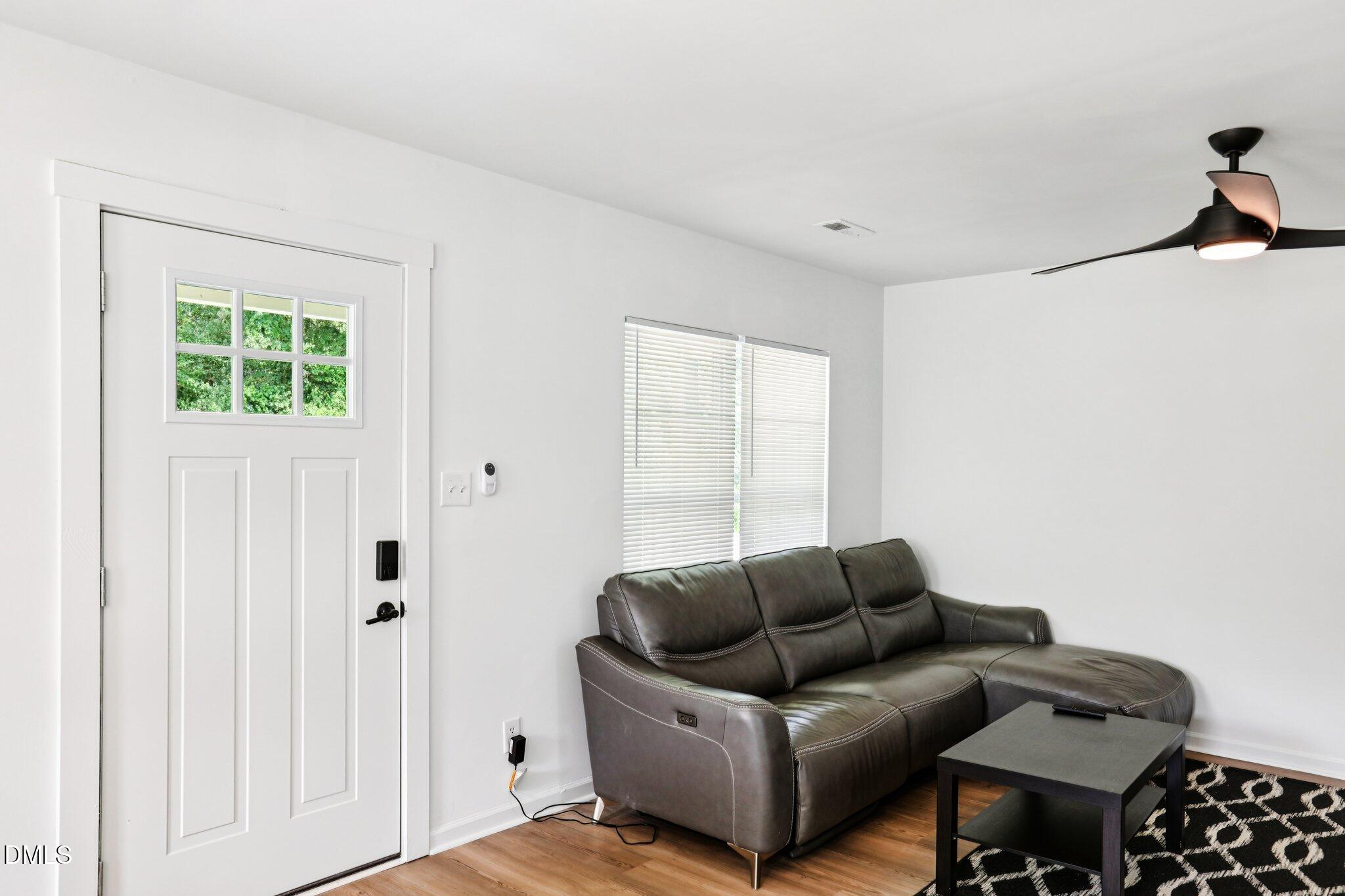 1349 Crabtree Boulevard Raleigh, NC 27610 - Photo 5 of 21 a living room with furniture a lamp and a window