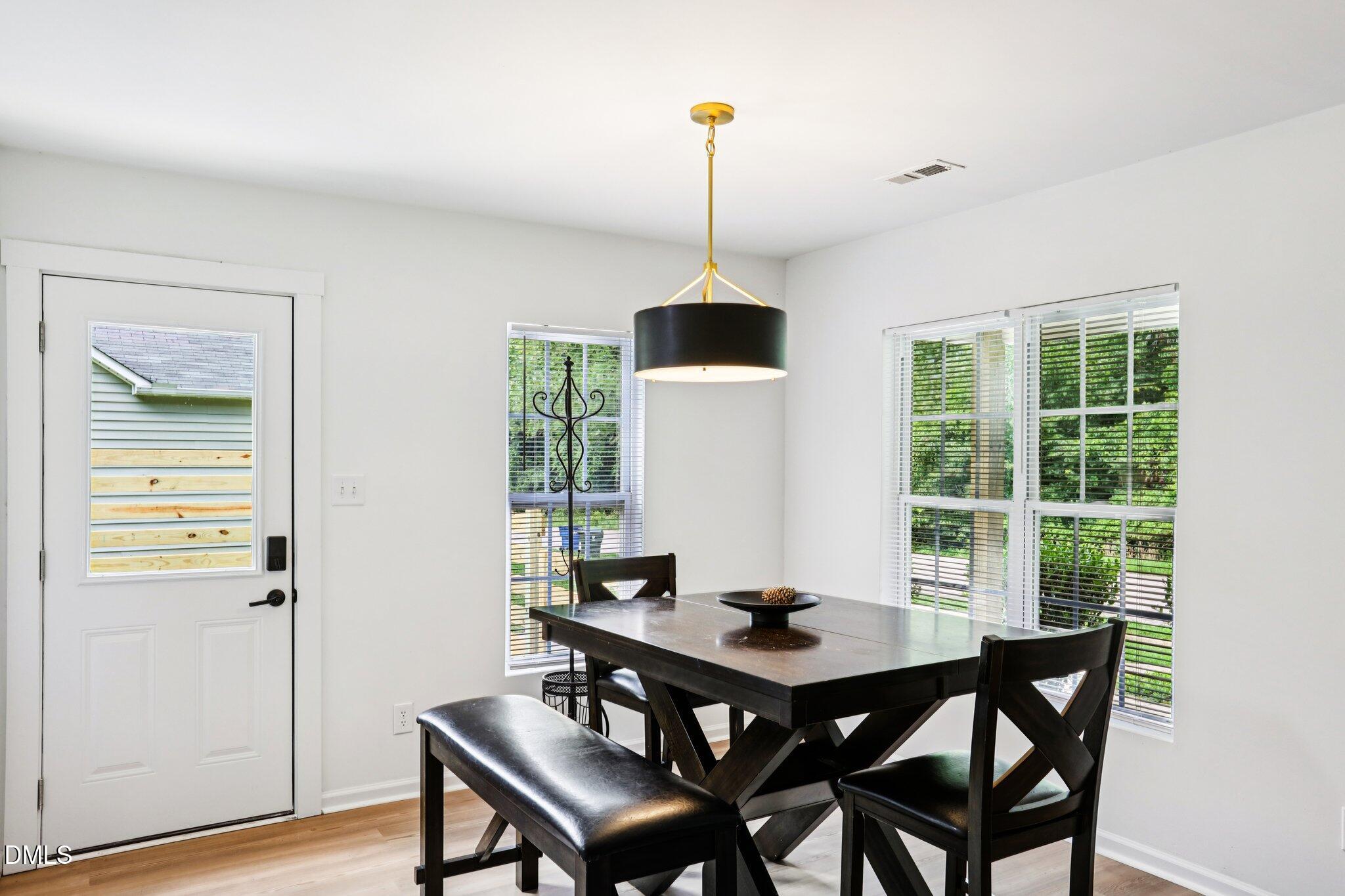 1349 Crabtree Boulevard Raleigh, NC 27610 - Photo 7 of 21 a view of a dining room with furniture window and wooden floor