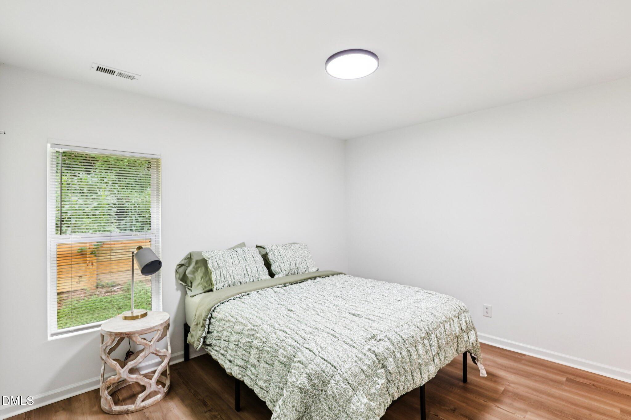 1349 Crabtree Boulevard Raleigh, NC 27610 - Photo 9 of 21 a bedroom with a bed and a window