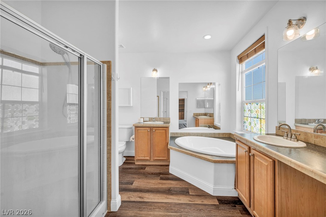 225 California Street Searchlight, NV 89046 - Photo 42 of 64 Indulge in a primary bathroom featuring a spacious shower, a soaking tub, and a dual vanity with ample counter space.