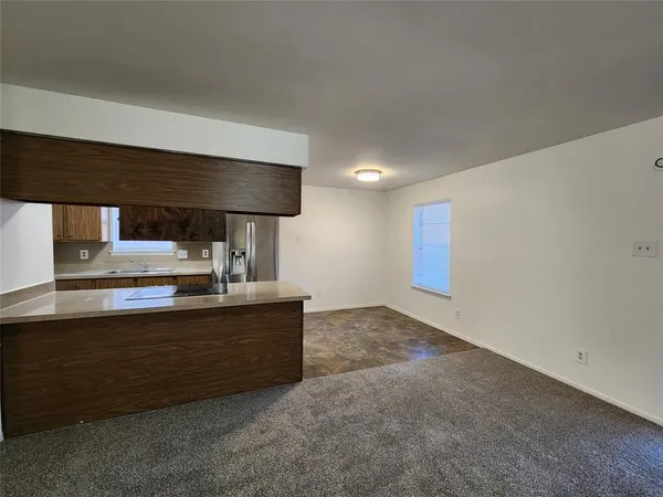 a view of kitchen with stainless steel appliances granite countertop cabinets and sink