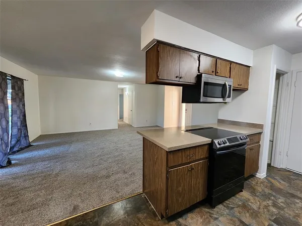 a kitchen with a stove and a microwave