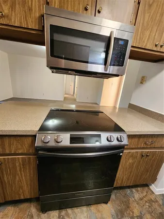 a stove top oven sitting inside of a kitchen