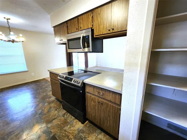 a kitchen with stainless steel appliances granite countertop a stove and a refrigerator