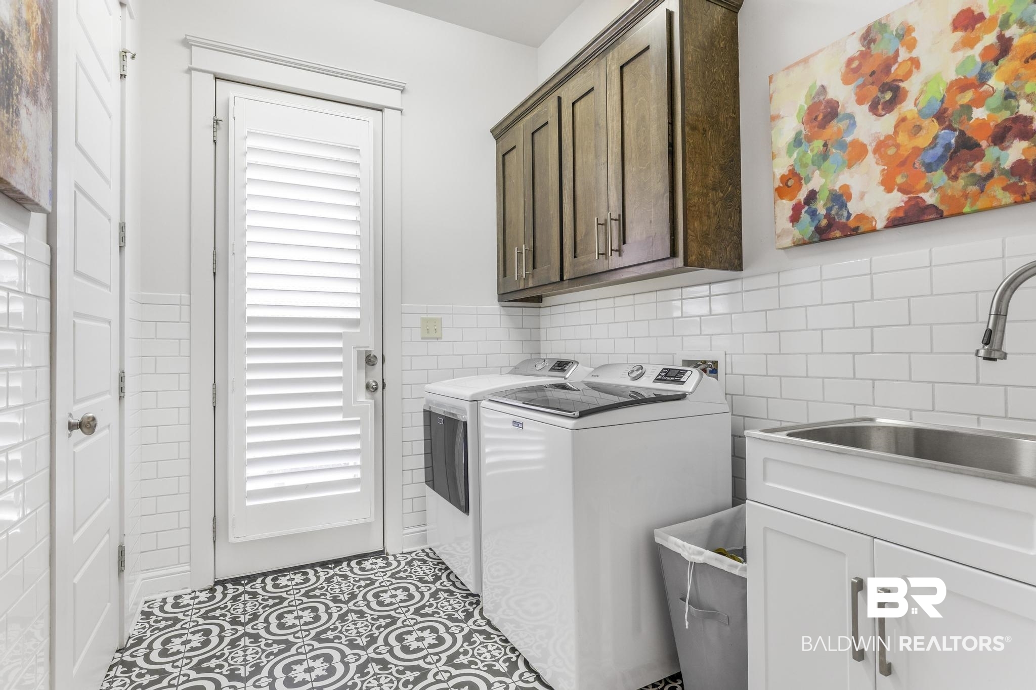 29949 Dolive Ridge Daphne, AL 36527 - Photo 29 of 55 Utility space featuring patterned floor tiles, white subway tile wainscoting, and a white louvered door