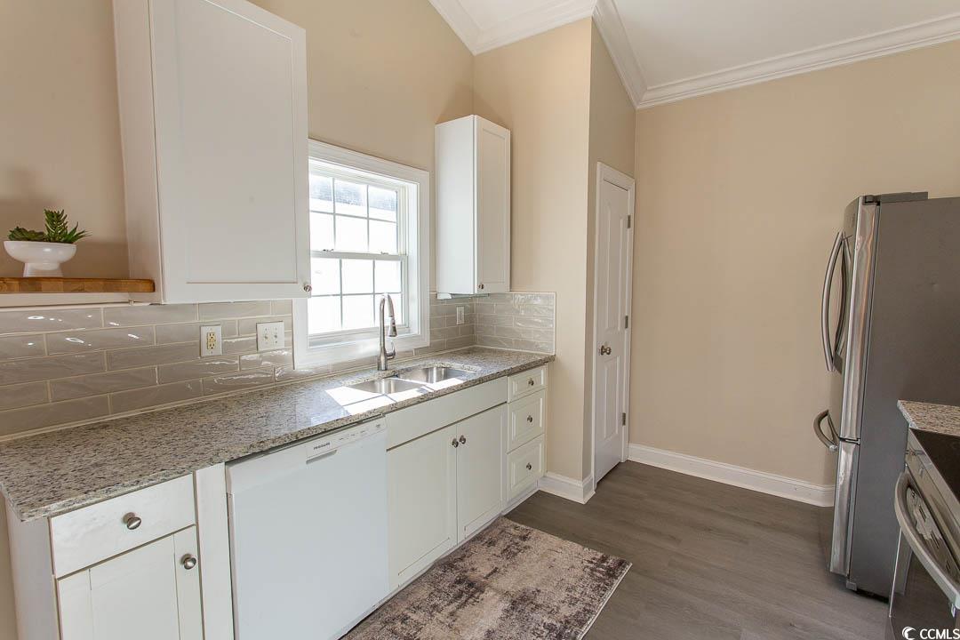 202 Sugar Mill Loop Myrtle Beach, SC 29588 - Photo 12 of 39 Kitchen featuring vaulted ceiling, tasteful backsp