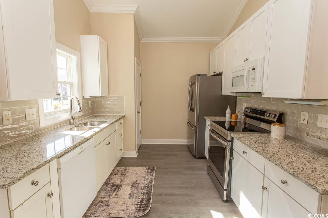202 Sugar Mill Loop Myrtle Beach, SC 29588 - Photo 13 of 39 Kitchen with sink, white cabinets, white dishwashe