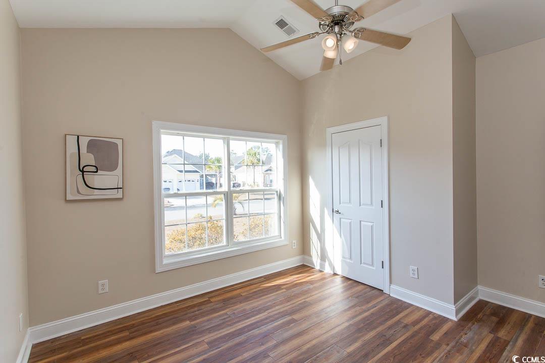 202 Sugar Mill Loop Myrtle Beach, SC 29588 - Photo 20 of 39 Empty room with dark wood-type flooring and vaulte