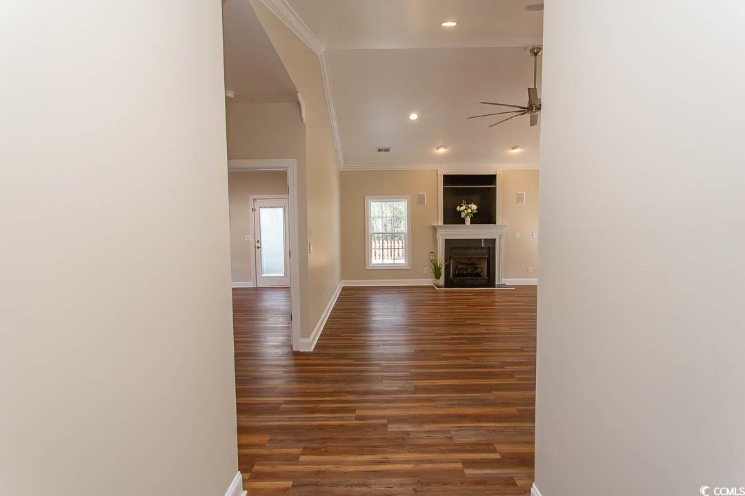 202 Sugar Mill Loop Myrtle Beach, SC 29588 - Photo 2 of 39 Unfurnished living room with ceiling fan, crown mo