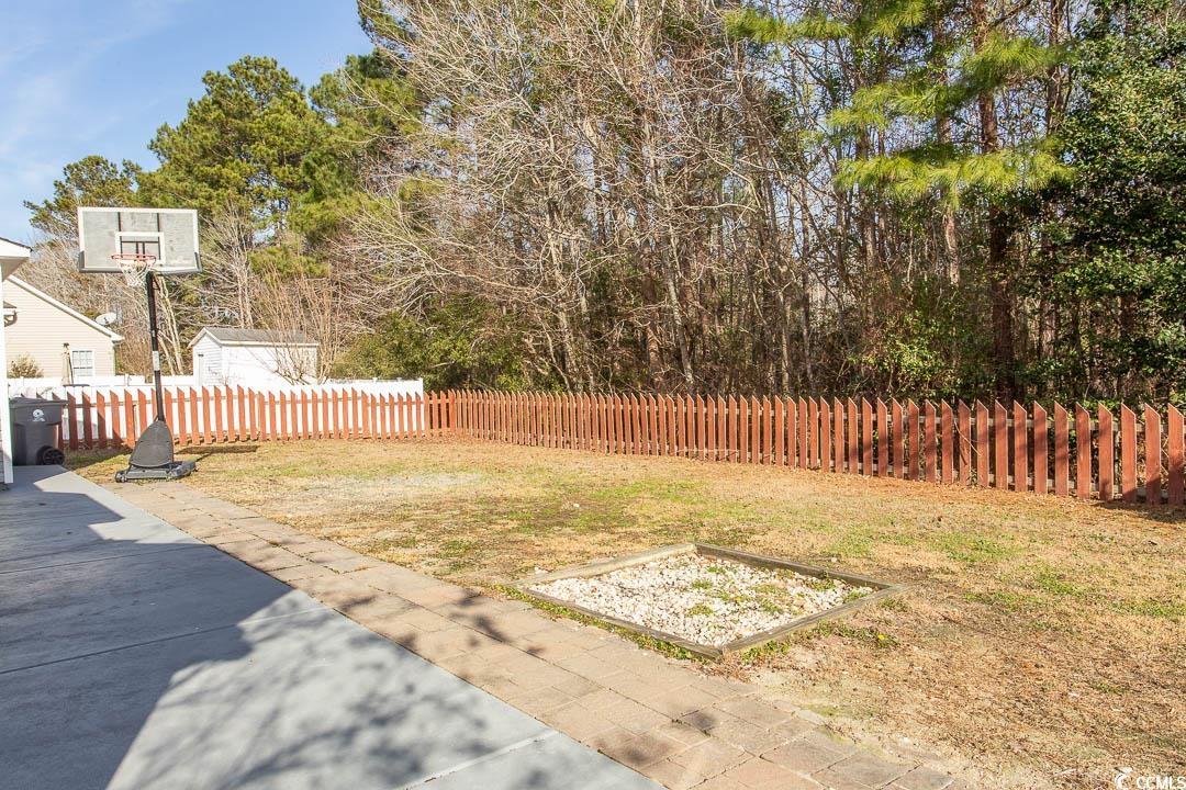 202 Sugar Mill Loop Myrtle Beach, SC 29588 - Photo 34 of 39 View of yard with a patio area and a storage unit