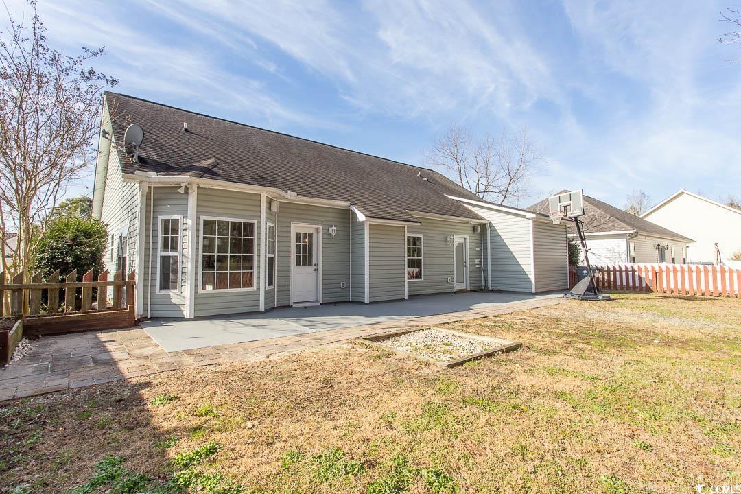 202 Sugar Mill Loop Myrtle Beach, SC 29588 - Photo 35 of 39 View of yard featuring a storage unit and a patio