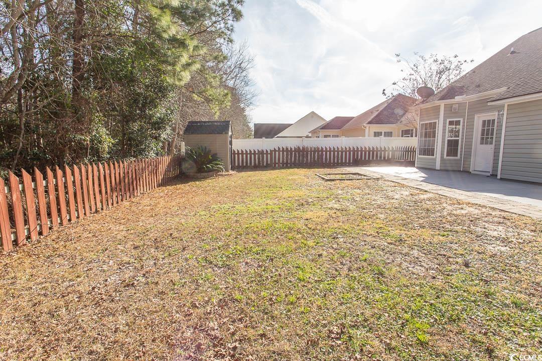 202 Sugar Mill Loop Myrtle Beach, SC 29588 - Photo 36 of 39 Back of property featuring a yard and a patio area