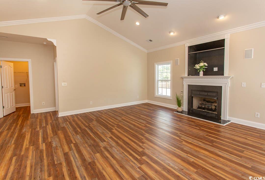 202 Sugar Mill Loop Myrtle Beach, SC 29588 - Photo 7 of 39 Unfurnished living room featuring dark wood-type f