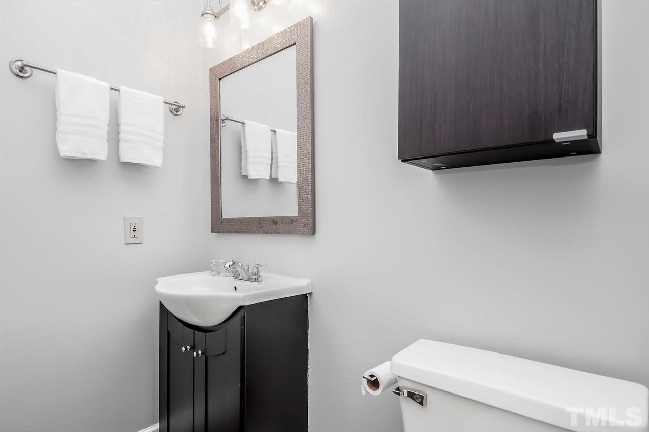 1001 Brighthurst Drive, Unit 103 Raleigh, NC 27605 - Photo 13 of 16 a bathroom with a sink and a toilet