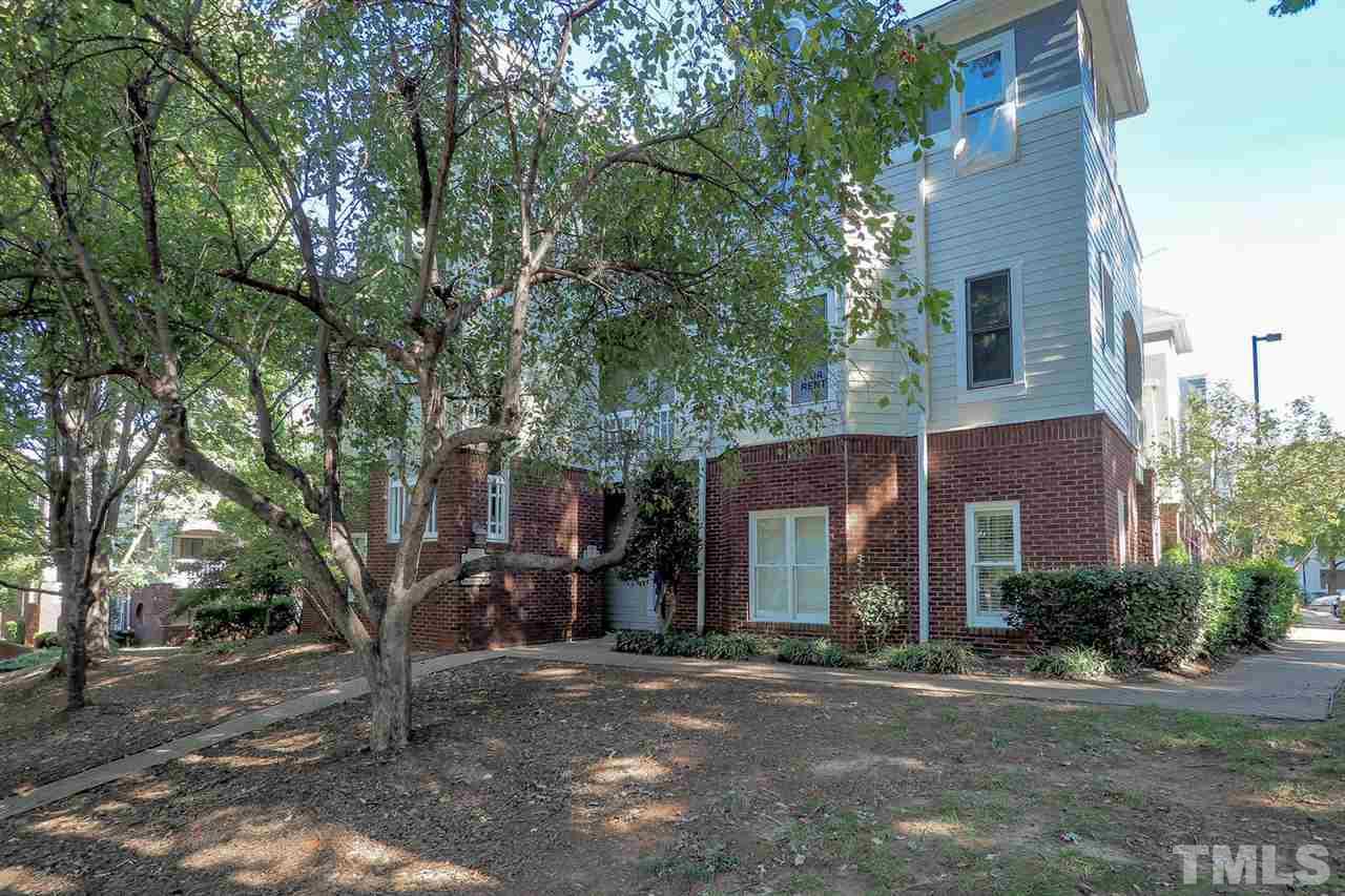 1001 Brighthurst Drive, Unit 103 Raleigh, NC 27605 - Photo 15 of 16 a front view of a house with a yard and garage