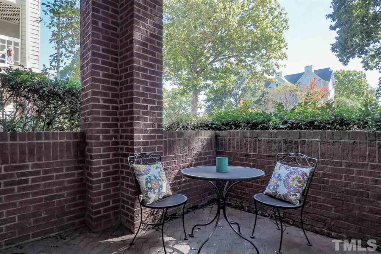 1001 Brighthurst Drive, Unit 103 Raleigh, NC 27605 - Photo 16 of 16 a view of a chairs and table in backyard